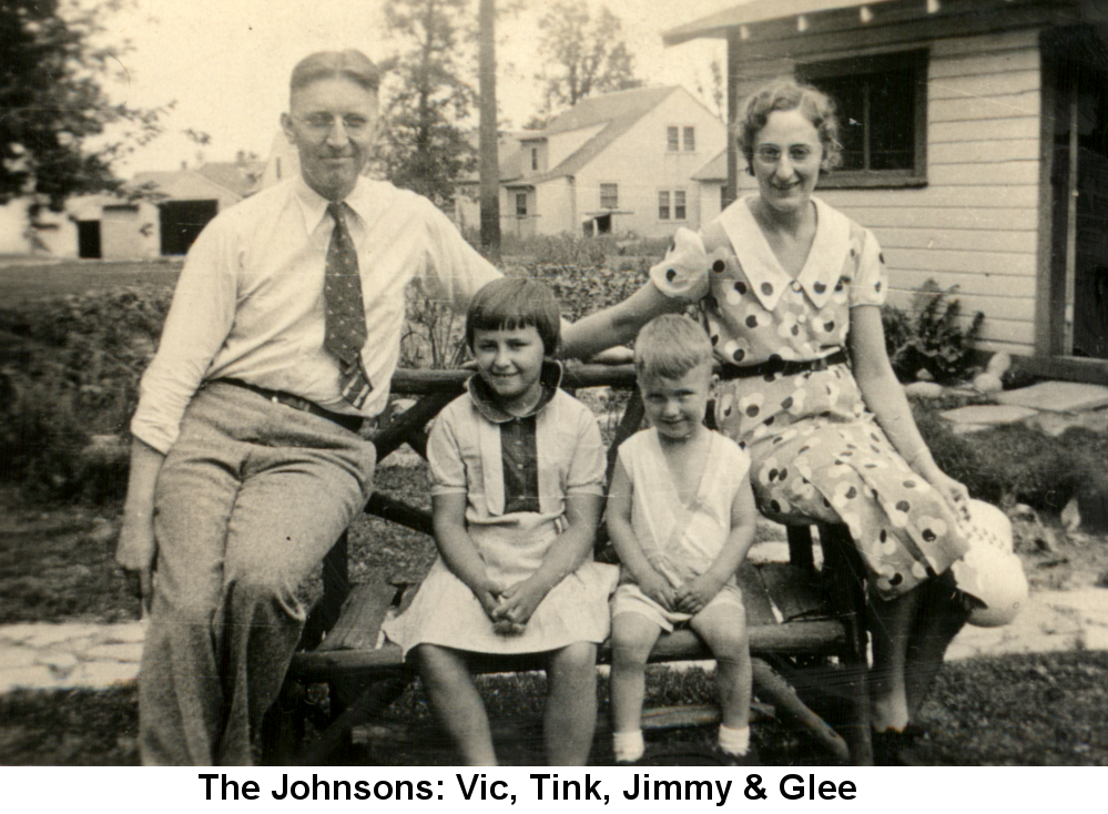 Black and white photo of Victor Johnson, Shirley 'Tink' Johnson, James Jeffrey Johnson, and Glee Dibble Johnson sitting on a log bench in front of a stone walkway behind a frame house.